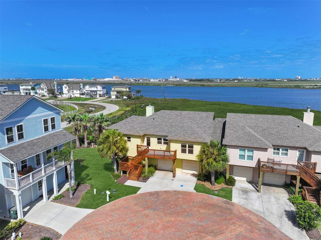 Welcome to 2807 Izamal Court! This better-than-new islander home in Galveston's small & secluded Campeche Shores community is a bird water's paradise, nestled between the marshy banks of Sydnor Bayou and the immaculate grounds of the Moody Gardens Golf Course.