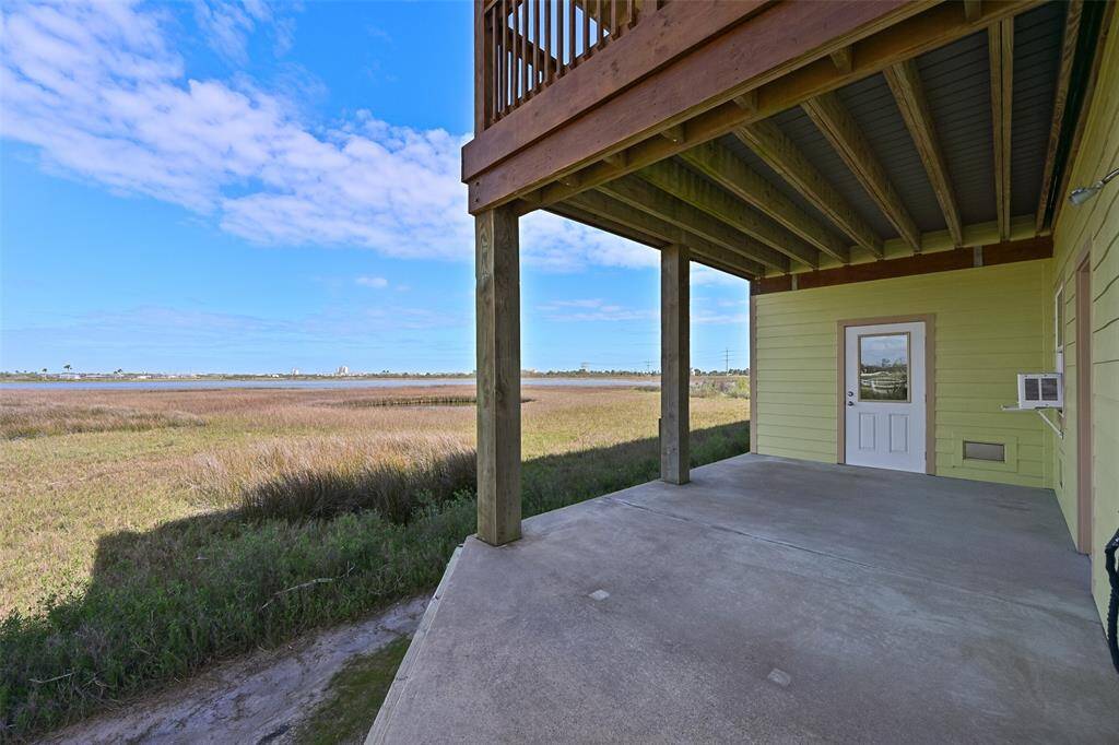 Step outdoors from the garage or the bonus room to this wrap-around concrete patio that stretches all the way around to the front of the home. It's a bird watcher's paradise over the marshland and golf course and you can always find shade with porches on both the front and back side of the home.