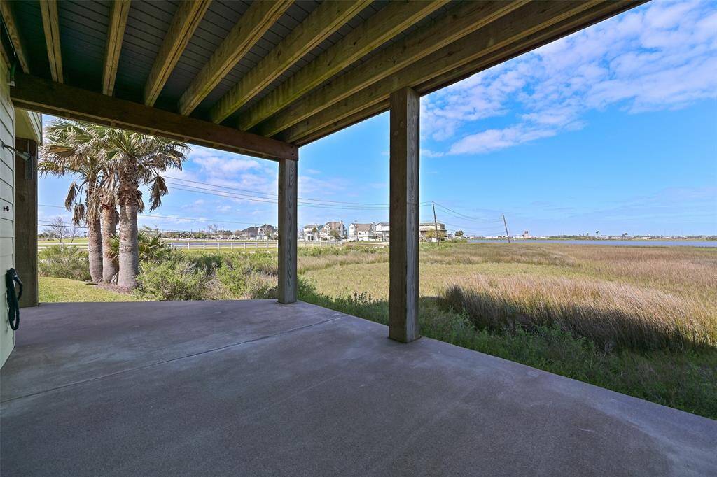 Step outdoors from the garage or the bonus room to this wrap-around concrete patio that stretches all the way around to the front of the home. It's a bird watcher's paradise over the marshland and golf course and you can always find shade with porches on both the front and back side of the home.