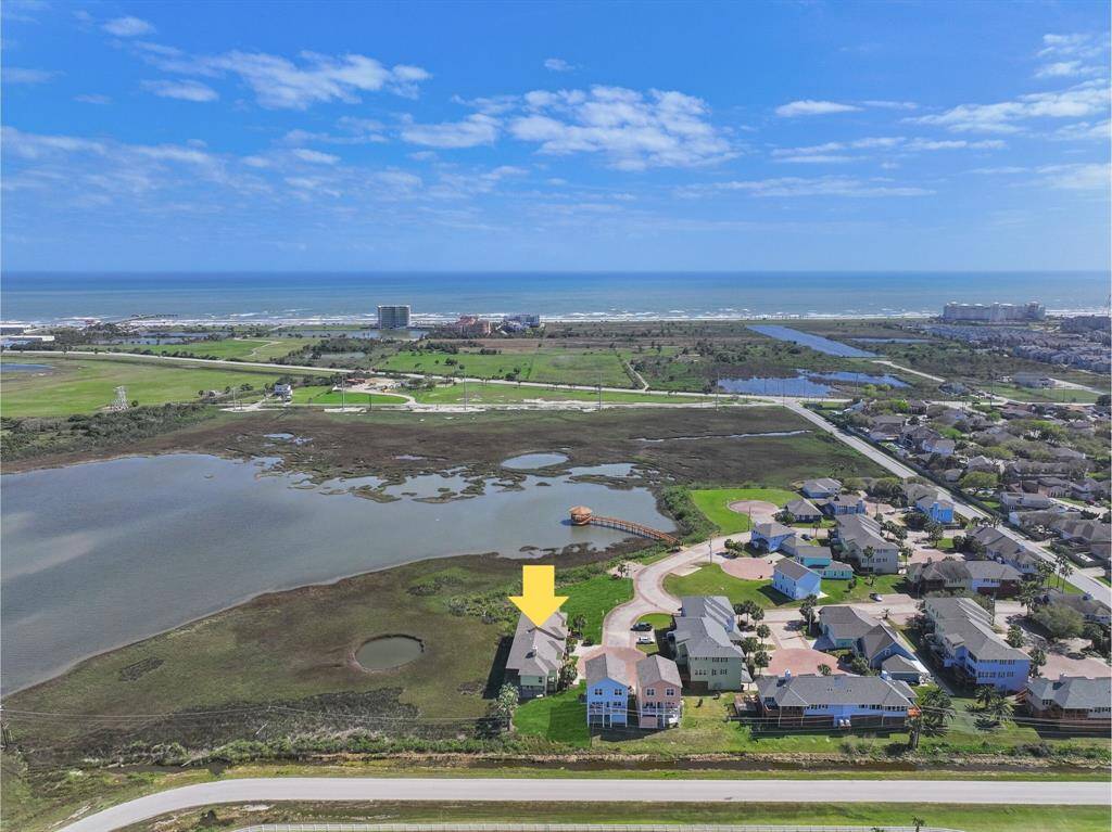 One last aerial view of the home looks northward towards the Galveston beach shoreline, where you can be relaxing in the sand under an umbrella with a book, wading out and wetting a line in the water, or chasing the littles in the waves. This is one property that truly has it all - you've got to see it to believe it!