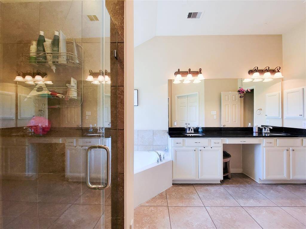 The Primary restroom features both a standing shower and Jetted Tub!
