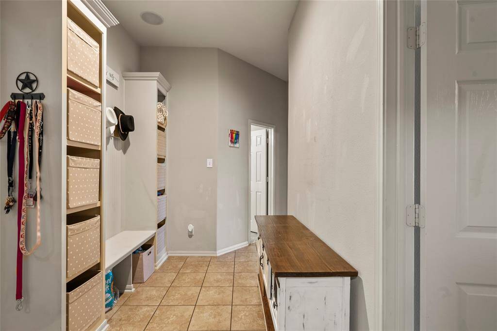 Hallway leading to the utility room, three spare bedrooms, and secondary bath