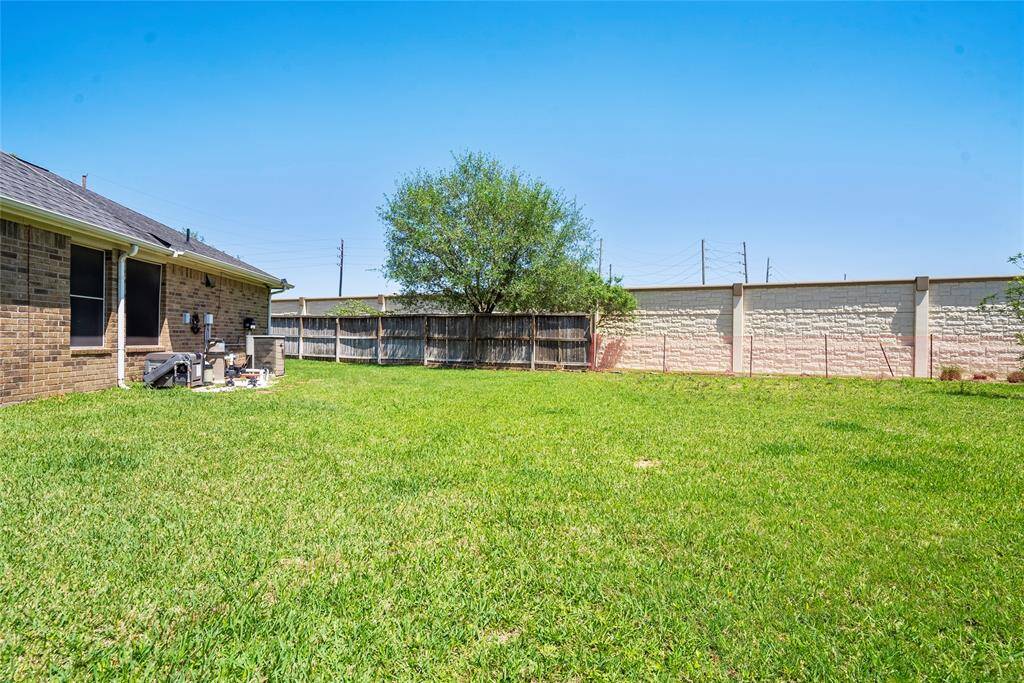 Extra yard space featuring the sound wall and and where the HOA is replacing the fence