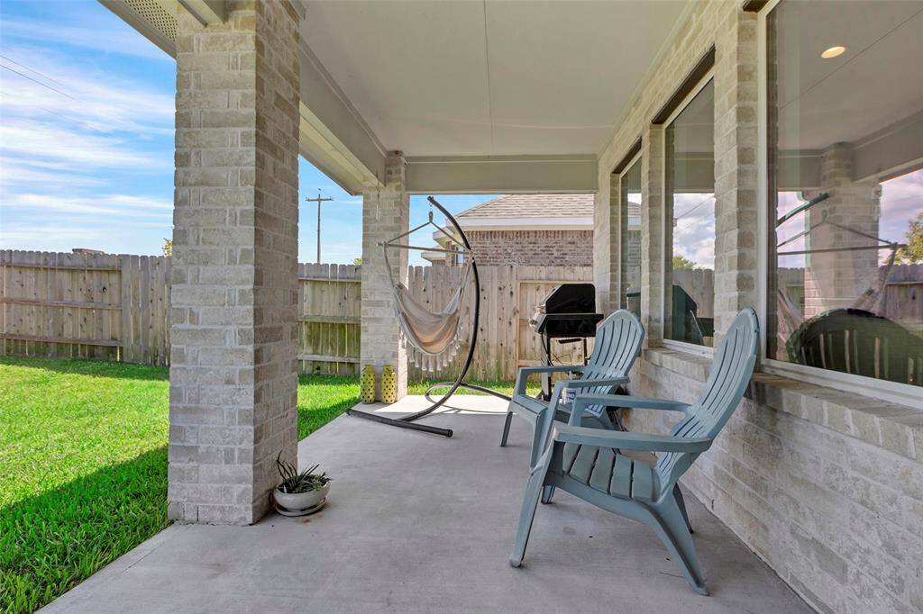 The back patio is the perfect retreat to unwind after a long day, offering a serene space to relax with a drink in hand.