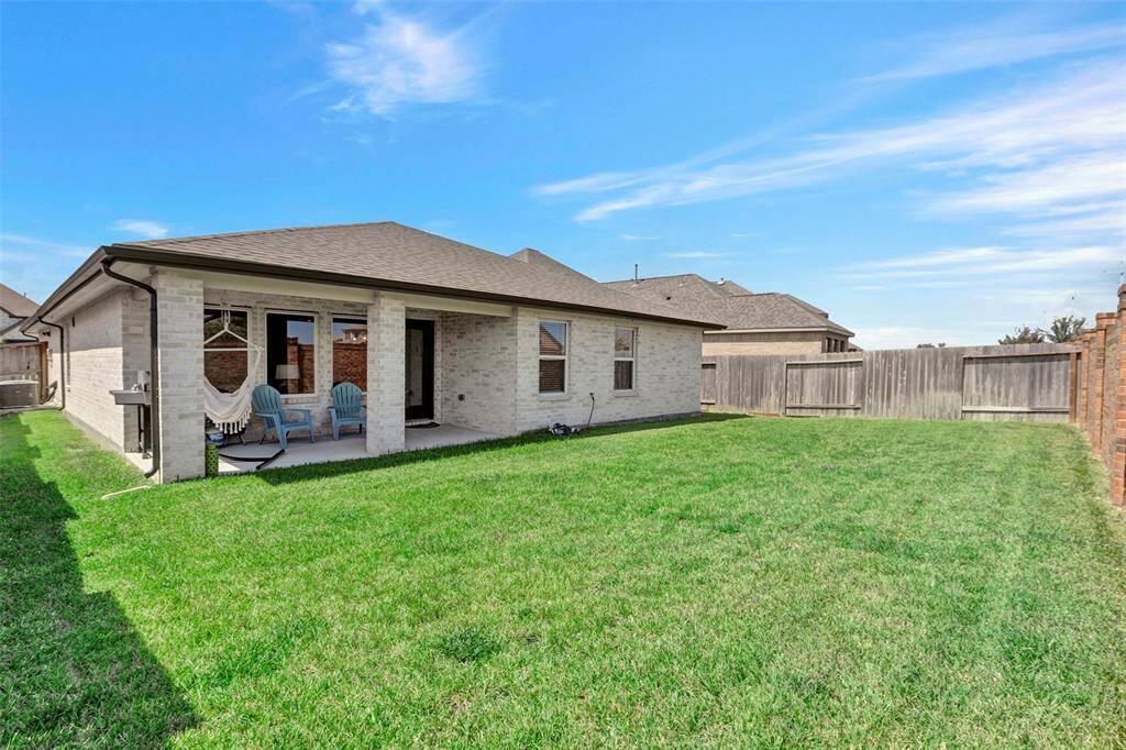 The backyard basks in abundant sunlight throughout the day, making it an ideal space for a kids' playground or outdoor activities.
