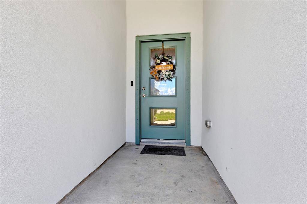 This unique home features a front door accessed through a hallway that separates the garage from the front bedroom.