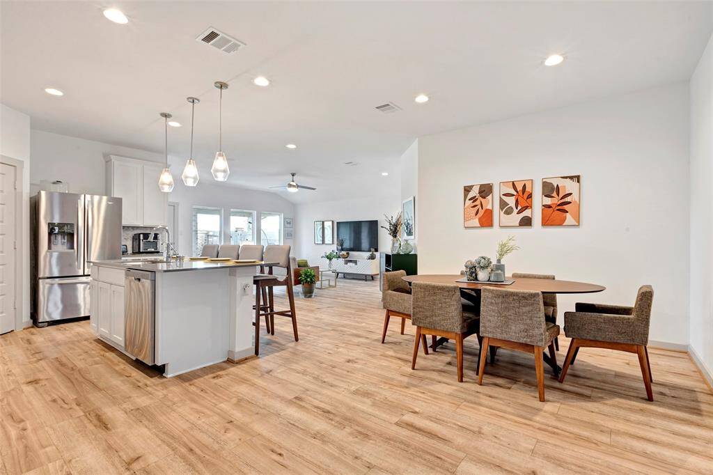 Experience the seamless flow of this home with a stunning view of the open-concept living area, kitchen, and dining space, perfect for entertaining and everyday living.
