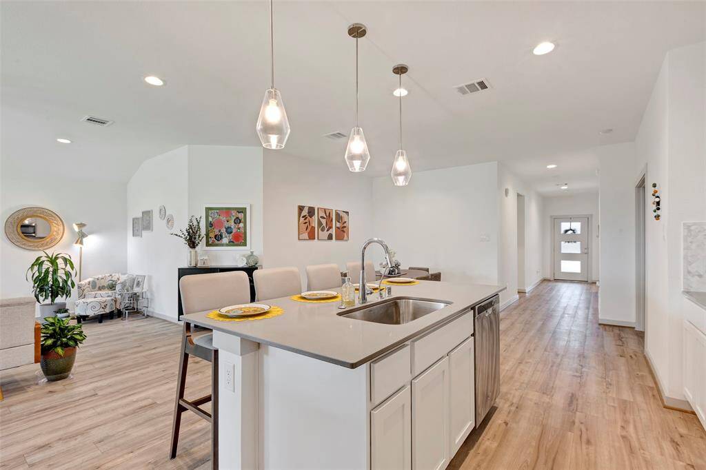 The stylish kitchen island doubles as a convenient breakfast bar, making it the perfect spot for casual meals and socializing.