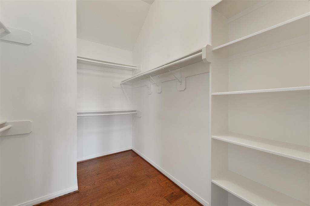 Generous sized primary closet with built in shelves.
