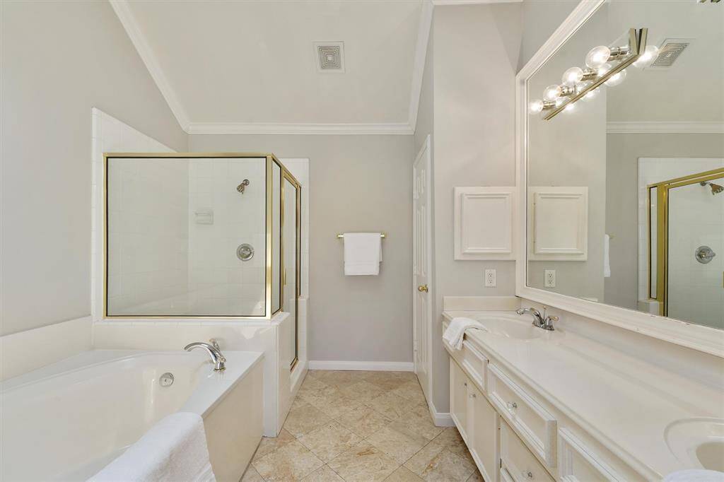 Primary bath with soaking tub and separate shower. Freshly painted.