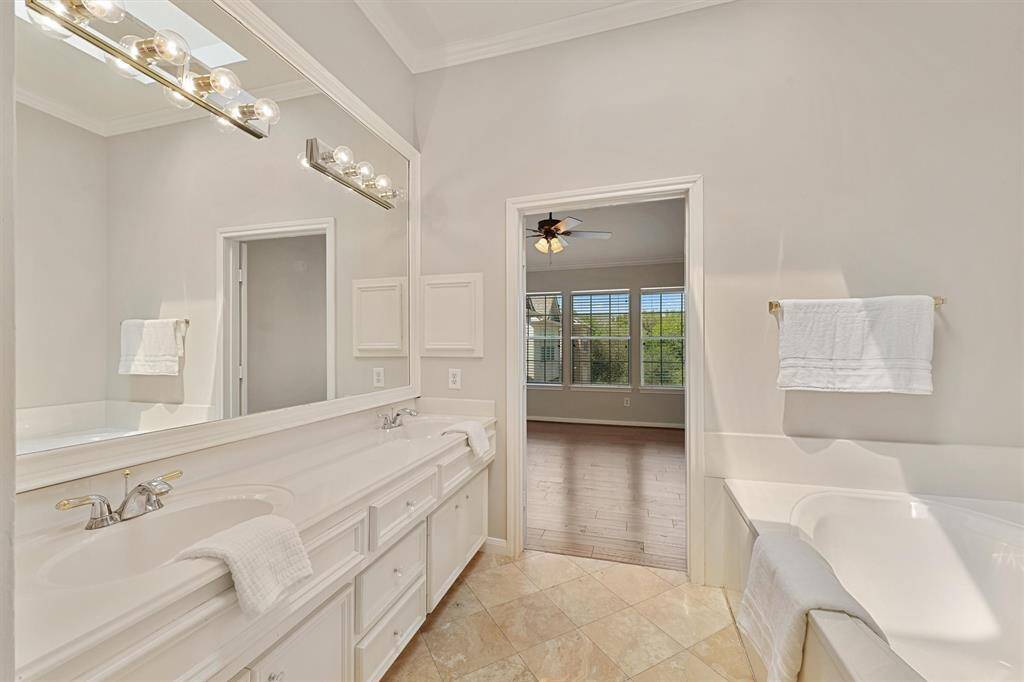 Primary bath with double sinks. Skylight brings in natural light.
