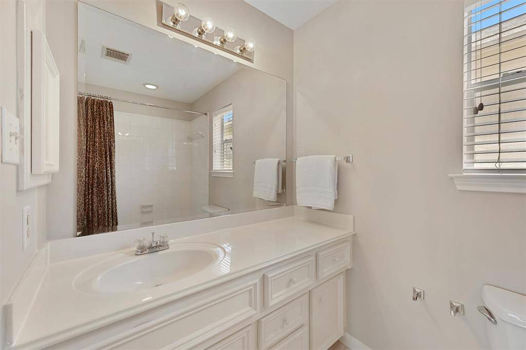 Full bath on the third floor with tub and shower combination.