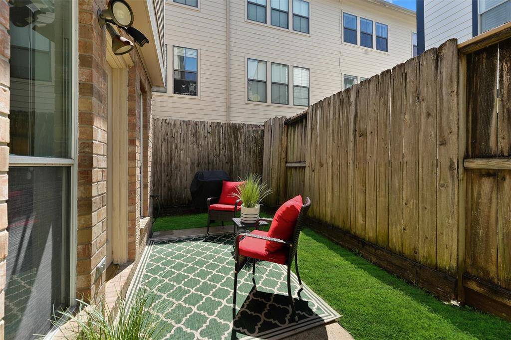 Fully fenced yard with concrete slab patio.