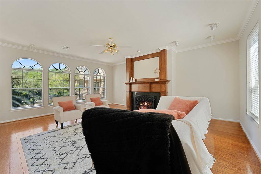 Wall of windows let in natural light on the second floor main living area. Floor to ceiling custom wood mantle gas fireplace.