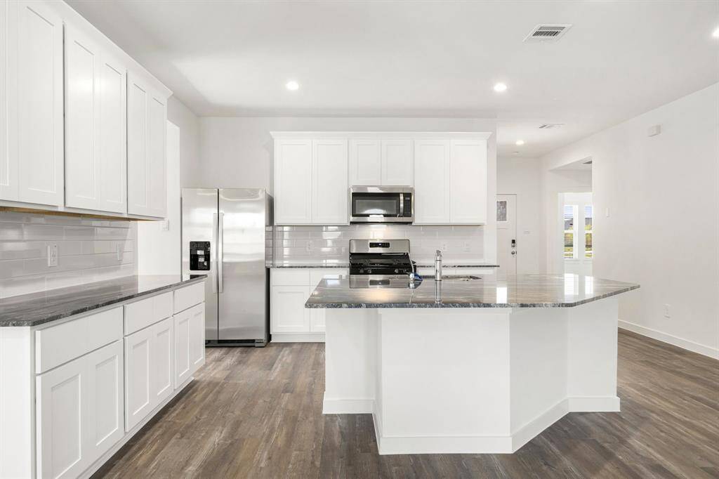 Any chef's dream, this stunning kitchen is perfect for everyday life as well as entertaining family and friends! Extra large kitchen island is perfect for conversation or that much needed space to lay out your party spread for everyone to enjoy! Large windows provide lovely views of your backyard and plenty of natural lighting throughout the day.