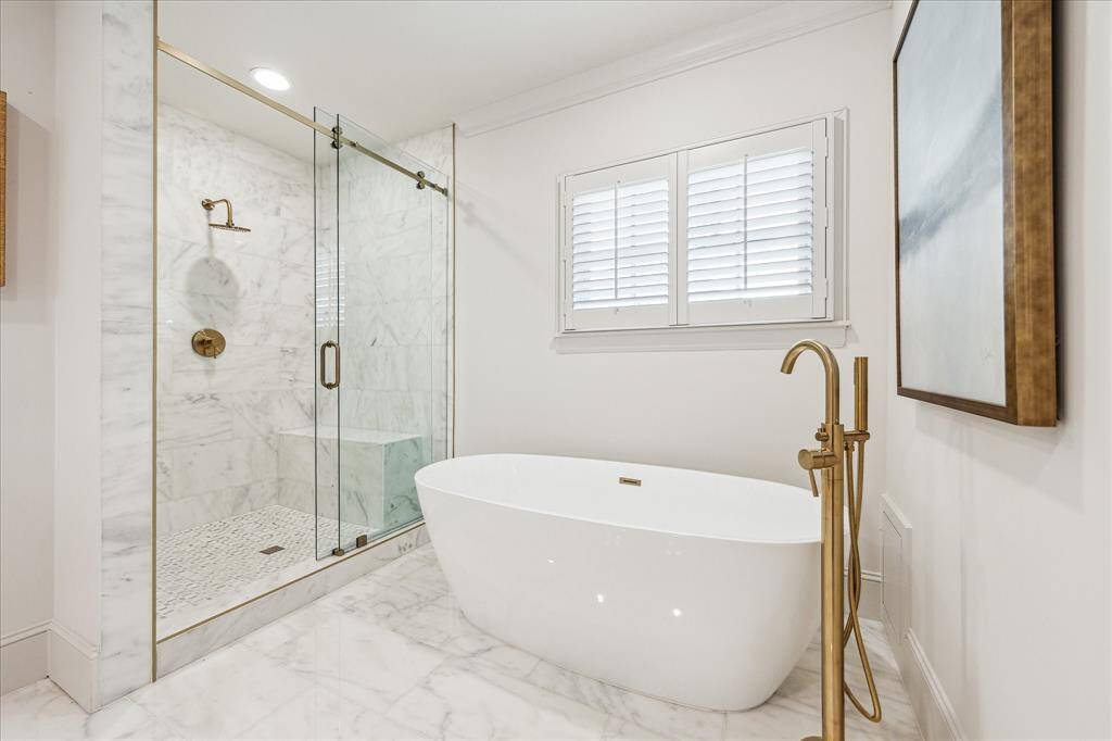 Such a sleek modern design for the Primary Bath with shuttered window above.