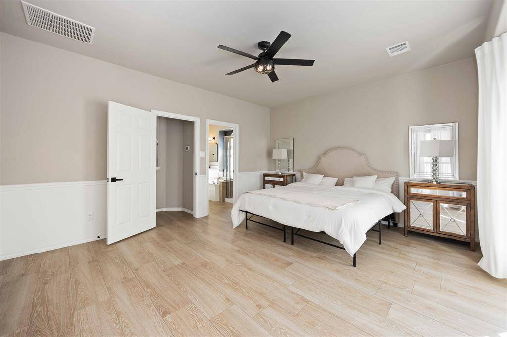 A fresh perspective of the spacious primary suite, looking toward the elegant ensuite — showcasing the room’s flow, natural light, and luxurious design.