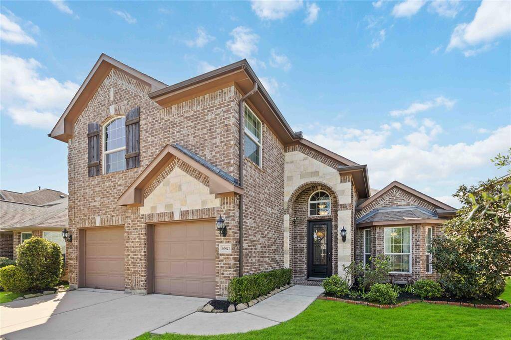 Exquisite curb appeal with a beautifully manicured exterior and generous front yard space — setting the tone for the elegance found within.