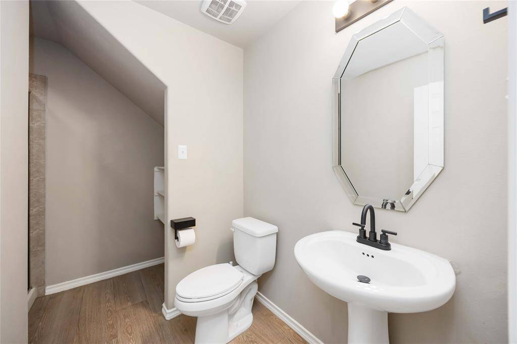 Full bathroom on the first floor featuring a stand-up shower, perfectly situated for the nearby secondary bedroom — ideal for guests or multi-generational living.