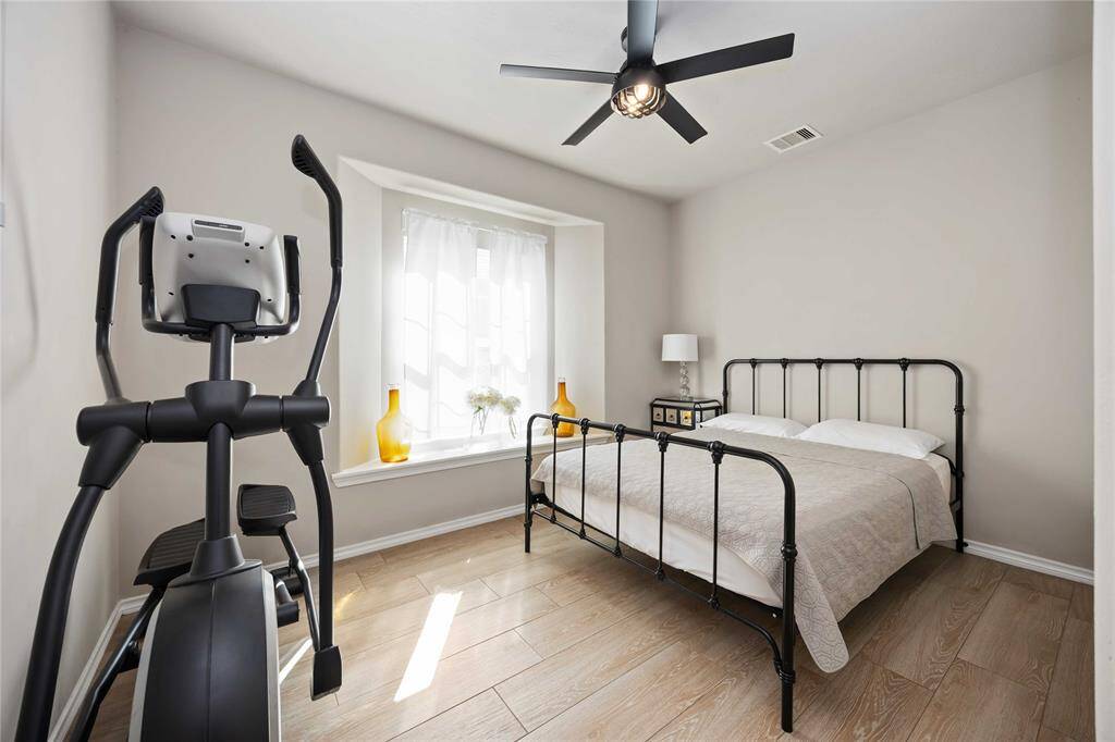Versatile first-floor secondary room that can easily serve as a guest suite, home office, gym, or playroom — tailored to fit your lifestyle needs.