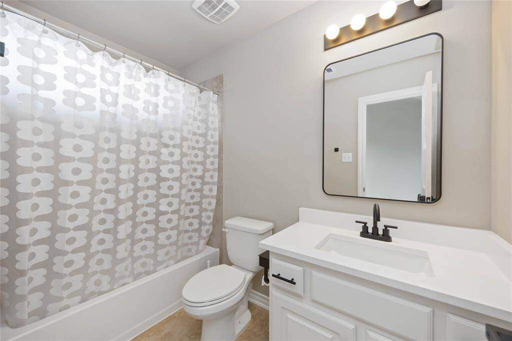 Private ensuite bath for the third bedroom, featuring a sleek vanity, modern fixtures, and a tub-shower combo — designed for both style and convenience.