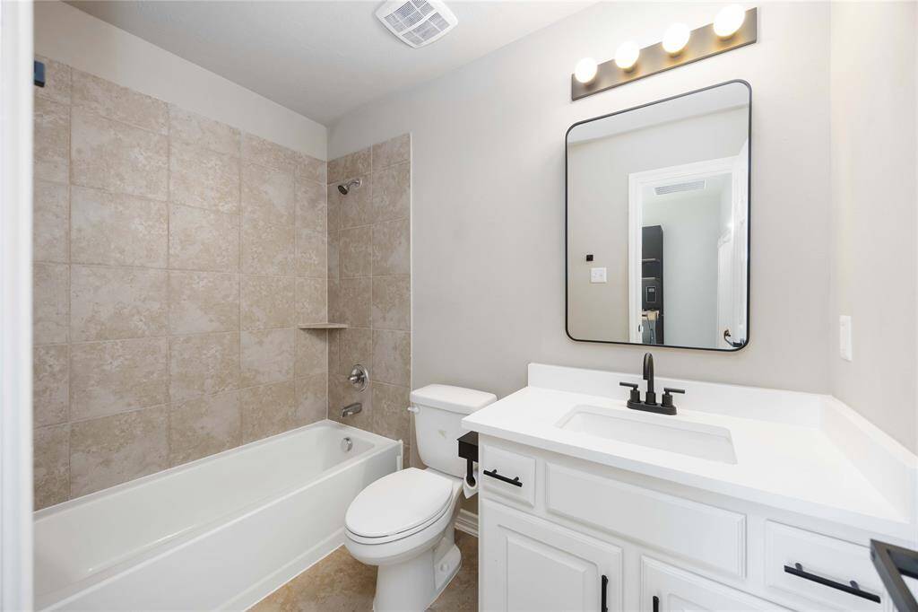 Well-appointed full bath located between the fourth and fifth bedrooms, offering shared access with thoughtful design, modern finishes, and plenty of space.