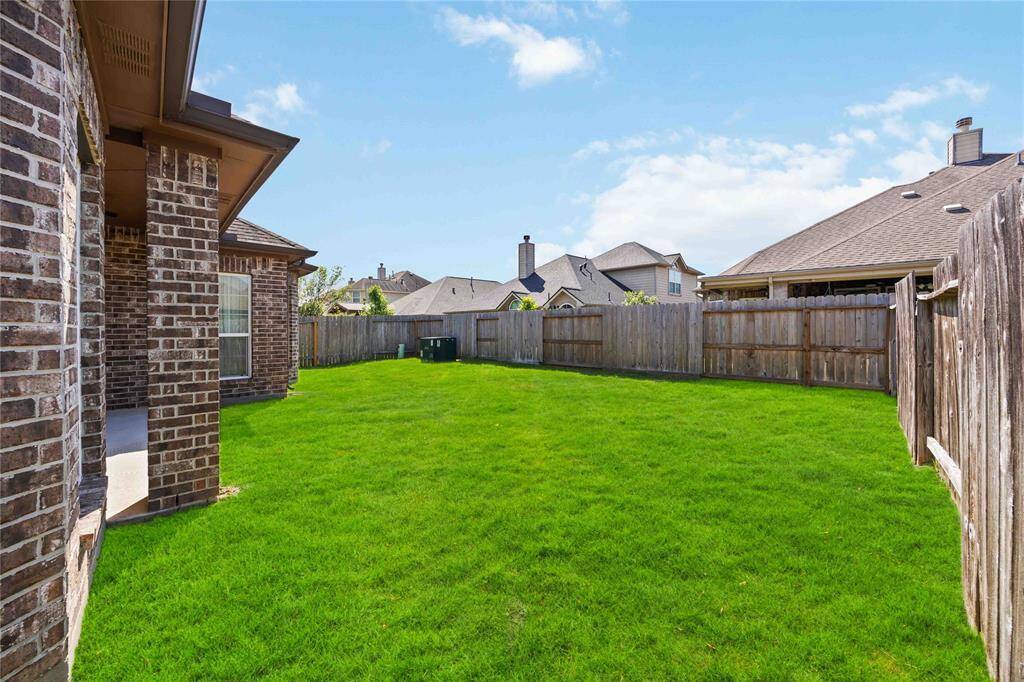 Spacious backyard with endless potential — whether you envision a garden, outdoor kitchen, play area, or serene retreat, this space is ready to be transformed.