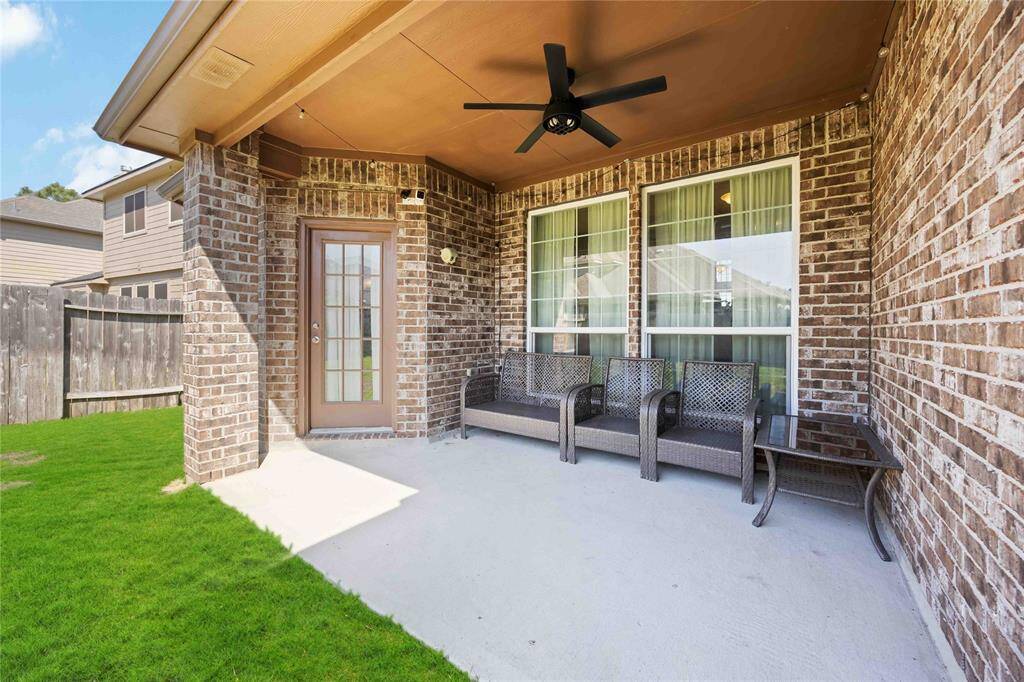 A closer look from this angle reveals the covered patio’s spacious layout, complete with stylish finishes and ample room for outdoor seating or entertaining.