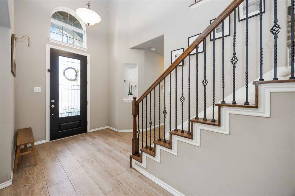 A stunning introduction to the open-concept entryway, where airy design and thoughtful details create an unforgettable first impression.