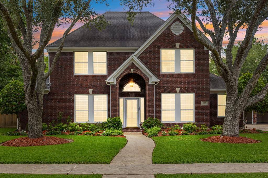 Stunning brown brick home nestled on Eagle Lake's largest lot, offering unmatched space and elegance. This custom beauty boasts a meticulously crafted stamped concrete driveway and sidewalk that welcome you in style. The expansive backyard provides endless possibilities—perfect for entertaining, relaxing, or building your dream outdoor oasis. A rare gem combining curb appeal, space, and craftsmanship in one of the most sought-after locations.