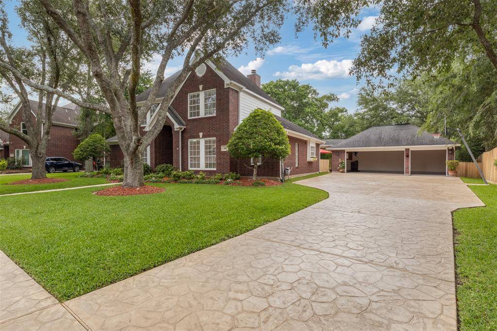This property features a spacious 3-car garage, complemented by a custom 3-inch thick stamped driveway.