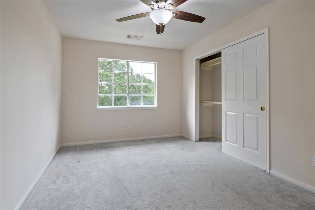 One of the three spacious upstairs bedrooms offers plenty of closet space and stunning views. Each of the three rooms is large and bright, making it the perfect setup for a growing family.
