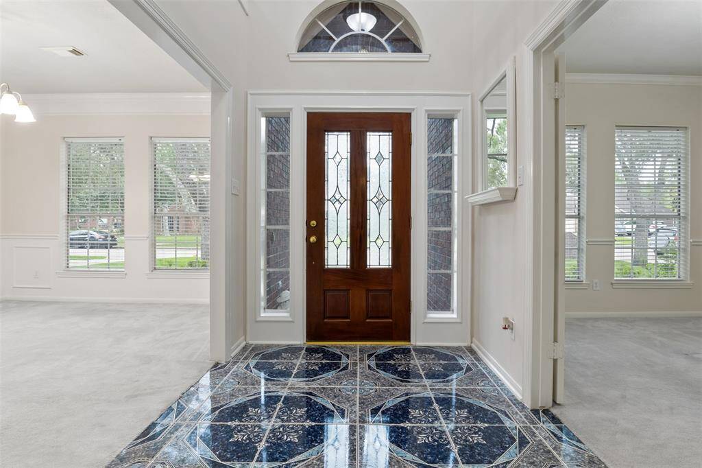 As you enter the front door, to your left you'll find the perfect office space or a woman's "she-shed." Make it your own and fill the room with your personal style. With beautiful double French doors, it offers both privacy and elegance, making it a great spot to relax or get creative.