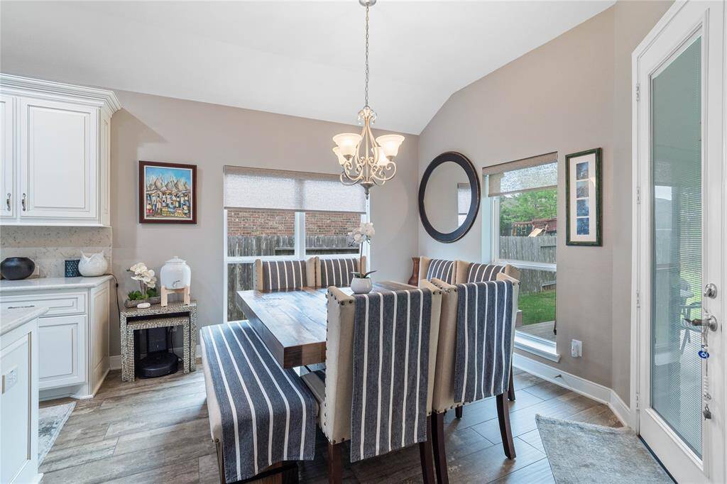 Spacious breakfast area with large windows and views of the backyard.