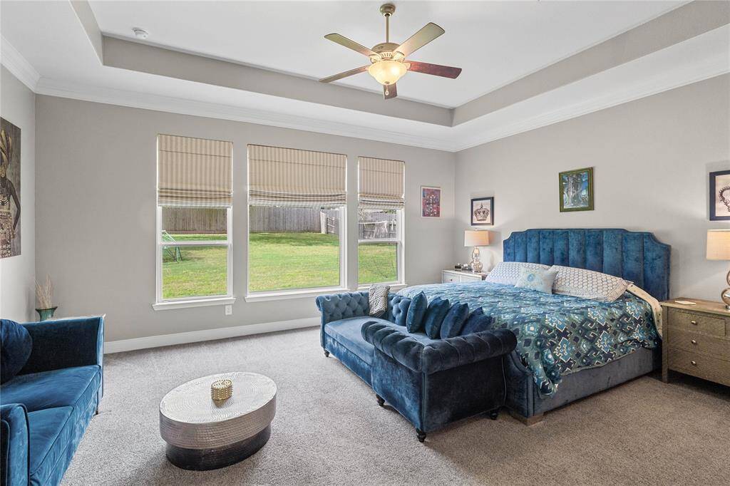 Primary retreat with en suite bath. Will easily accommodateoversized furniture. Large windows provide a view of the spacious backyard.