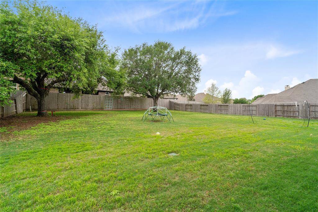 HUGE backyard with lots of green space for activities.