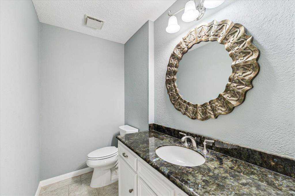 Half bathroom located off breakfast room