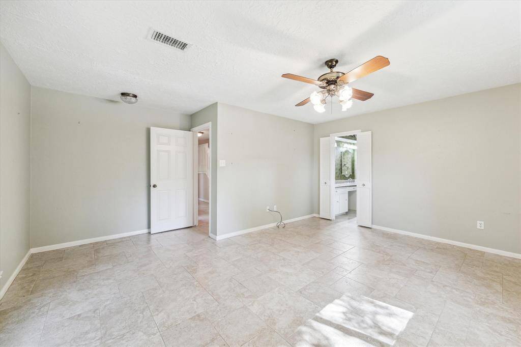 Primary bedroom with tile floors that flow throughout the downstairs