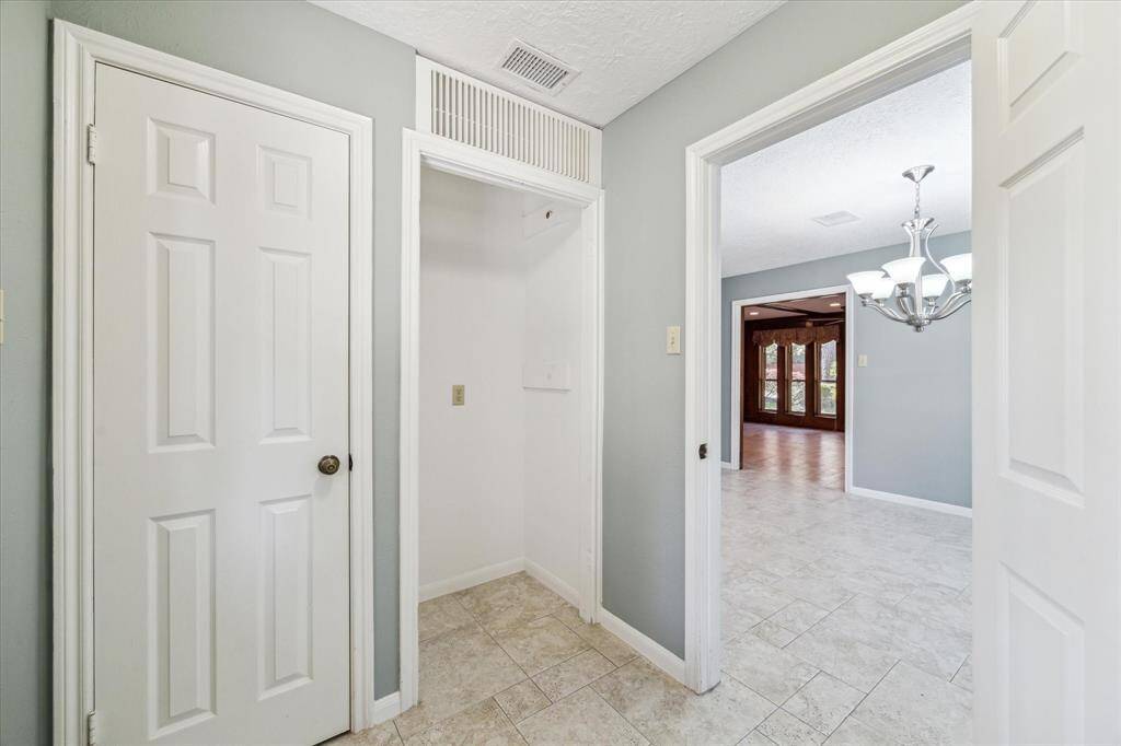 Laundry room has closet with shelves and space for another refrigerator or make it a mud area to store shoes