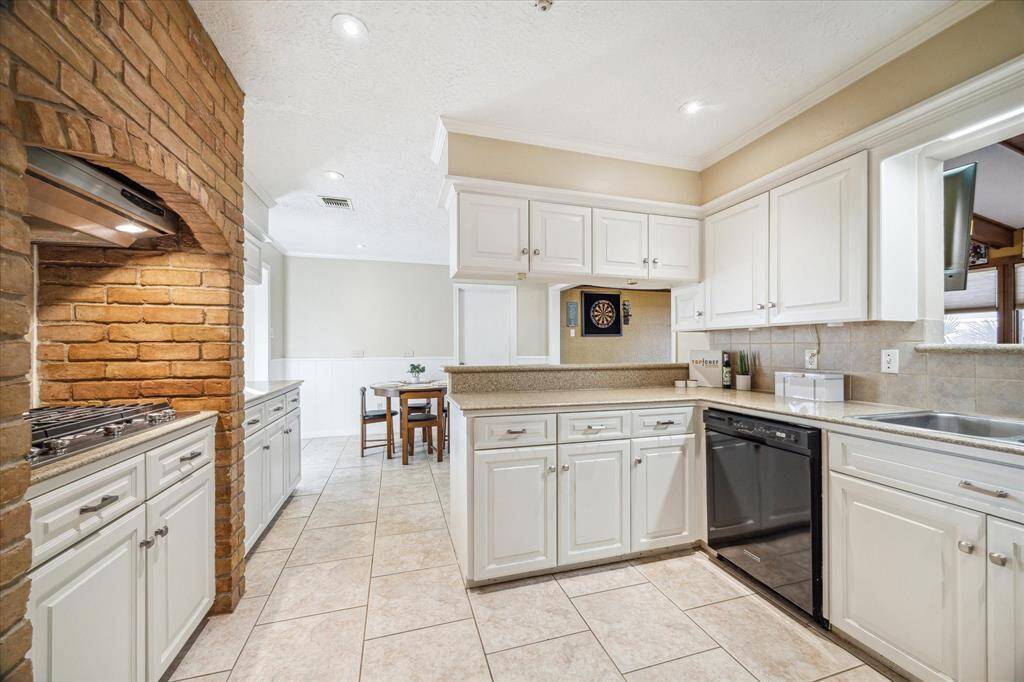 Show off your culinary skills in this beautiful kitchen. Find crisp white cabinetry, Silestone  countertops, tile backsplash, a large pantry, and sleek appliances.
