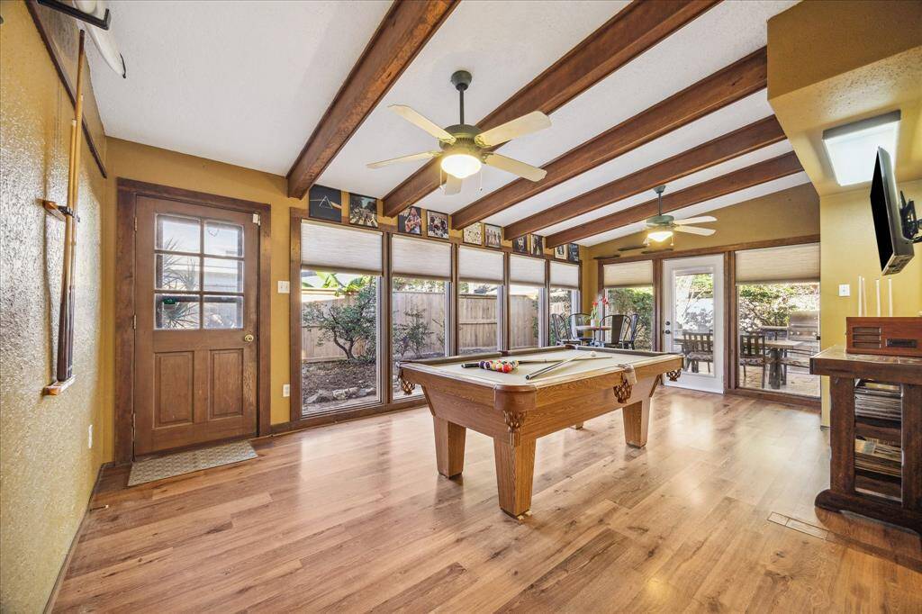 Surrounded by floor-to-ceiling windows, the space is bathed in natural light and offers ample room for your game table and other large furnishings.