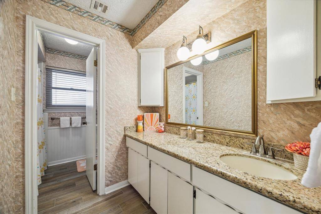 This full guest bathroom will be easy to share. It offers an extended single sink vanity and a private water closet.