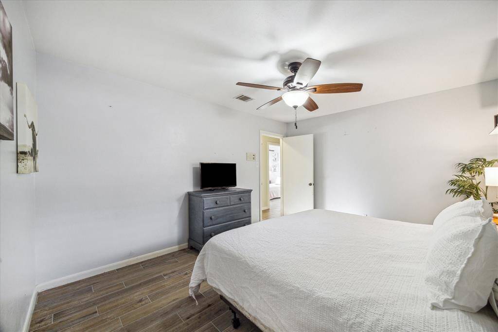 All three of the guest bedrooms are very spacious with updated wood-look tile flooring, neutral paint, lit fans, large closets and easy access to a full bathroom.