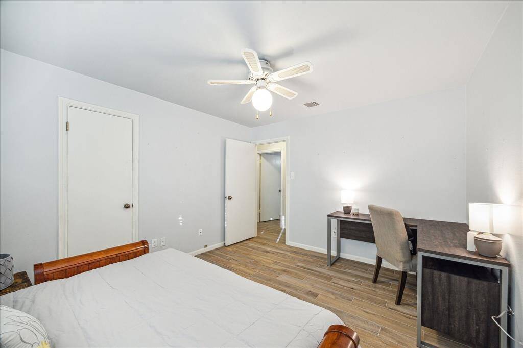 Another view of this roomy bedroom reiterates its spaciousness and warm inviting finishes.