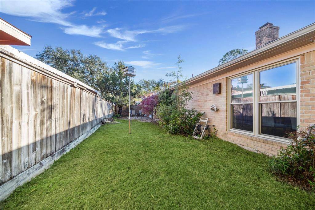 The spacious fenced yard offers plenty of green space for outdoor play. With a full sprinkler system, maintaining it is a breeze.