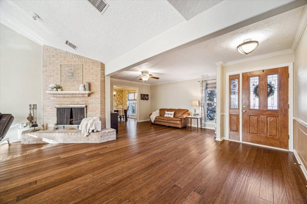 An iron gate and brick privacy wall at the front of the home create a wonderful “New Orleans” style courtyard entry with a covered patio and spacious fenced yard with a sprinkler system for easy care.