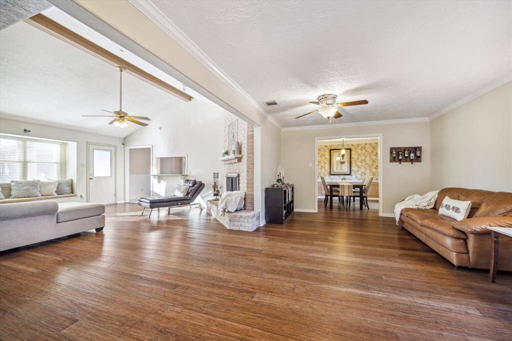 You're going to love this spacious floor plan with rich hardwood flooring, a stunning brick fireplace, and a welcoming open layout with ample space for comfortable living and entertaining.