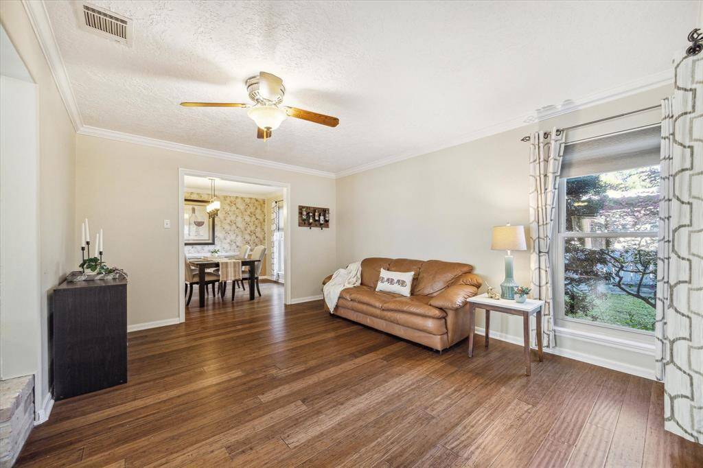 Step into this beautifully designed home, where a thoughtful open floor plan provides seamless flow between multiple living and dining areas. The main living area features gorgeous hardwood flooring, neutral paint, and ample natural light.