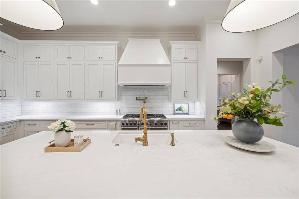 Custom McCaw cabinetry with large quartzite island make this kitchen a show stopper!