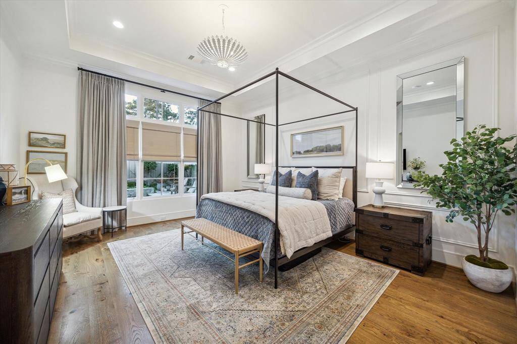 Amazing primary suite with coffered ceilings and wood paneled walls